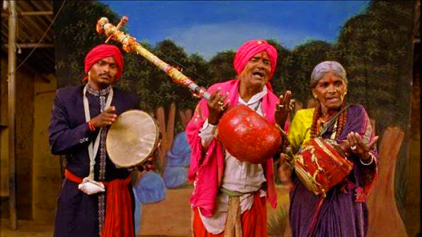 Traditional Burrakatha troupe performing on stage with instruments and expressive storytelling